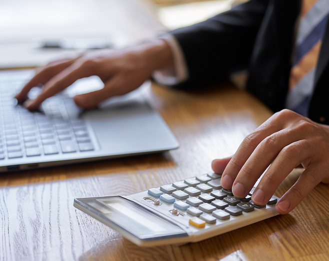 men typing in calculator