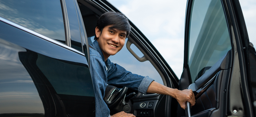 Man opened the EV car door smiling